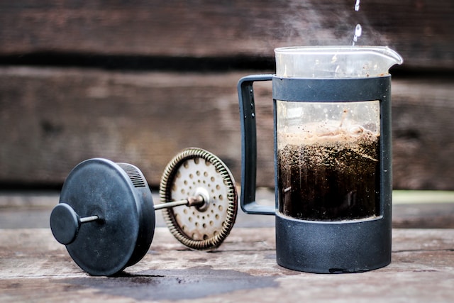 french press with hot coffee